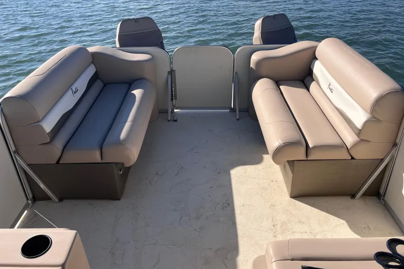 Slide: The Image of 2017 Fiesta 22 Beachcomber boat interior with beige seating, on calm water. - 13