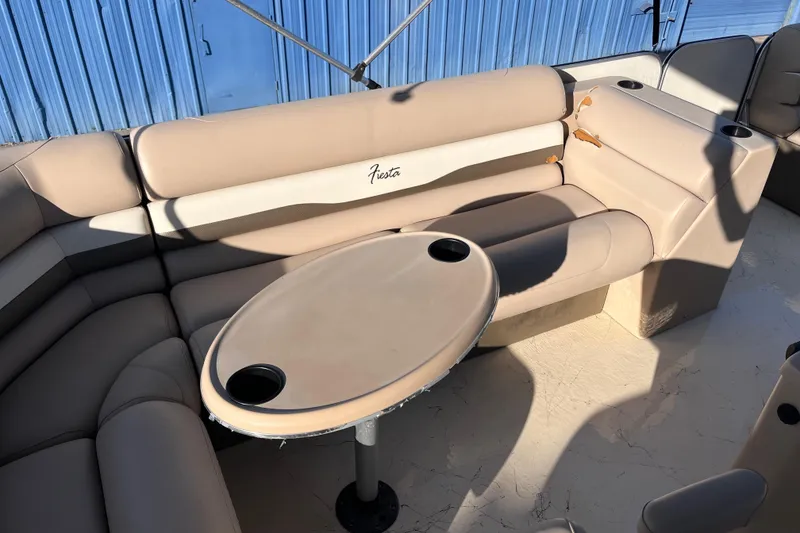 Slide: The Image of 2017 Fiesta 22 Beachcomber boat interior with beige seating and table. - 14