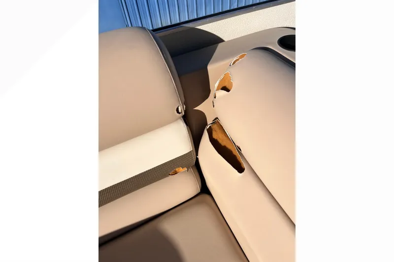 Slide: The Image of Damaged upholstery on 2017 Fiesta 22 Beachcomber boat seat, showing significant wear and tear. - 15