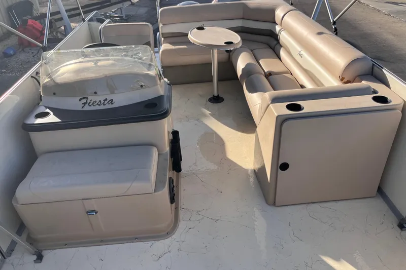 Slide: The Image of 2017 Fiesta 22 Beachcomber boat interior with beige seating and table. - 16