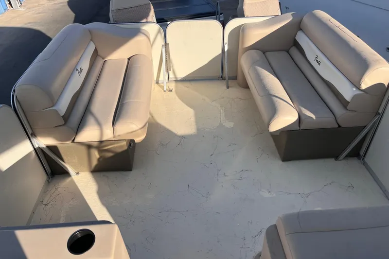 Slide: The Image of 2017 Fiesta 22 Beachcomber boat interior with beige seating and spacious layout. - 18