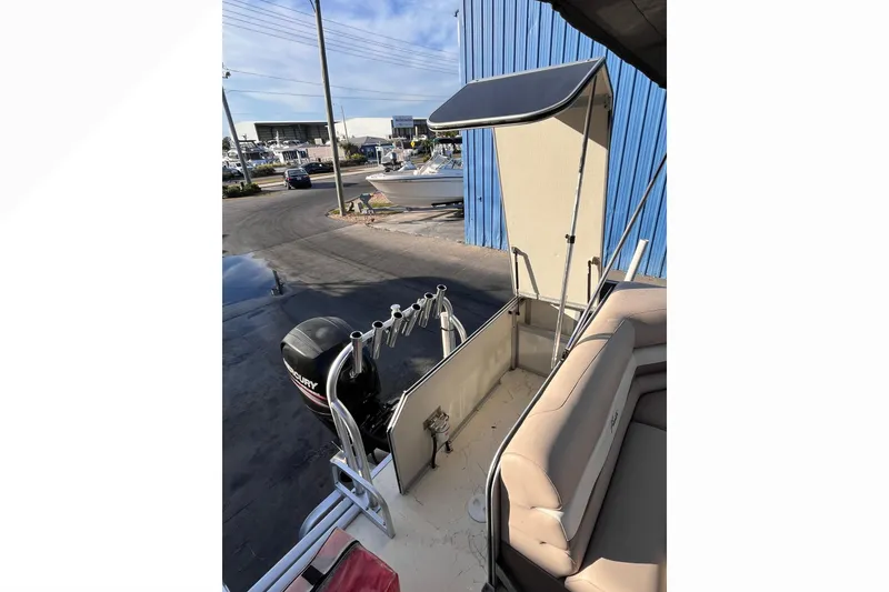 Slide: The Image of 2017 Fiesta 22 Beachcomber boat with Mercury engine, docked near blue building. - 20