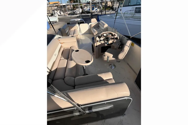 Slide: The Image of 2017 Fiesta 22 Beachcomber boat interior with beige seating and steering console. - 21
