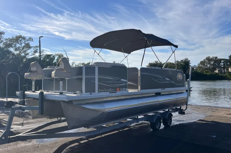 Slide: The Image of 2017 Fiesta 22 Beachcomber pontoon boat on trailer by a scenic waterfront. - 4
