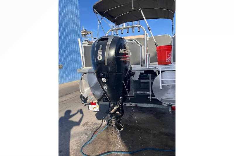 Slide: The Image of 2017 Fiesta 22 Beachcomber with Mercury 150 outboard motor, docked near blue building. - 6