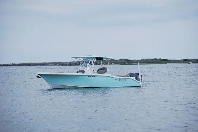 Slide: The Image of 2022 Key West 263 FS boat on calm water, overcast sky. - 2