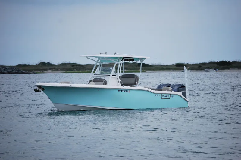 Slide: The Image of 2022 Key West 263 FS boat on calm water, overcast sky background. - 3
