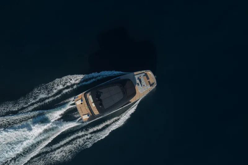 Slide: The Image of Aerial view of 2025 Bluegame BGM75 yacht cruising on dark water. - 22