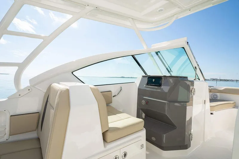 Slide: The Image of Interior view of 2026 Pursuit DC 266 Dual Console boat, showcasing helm and seating area. - 14