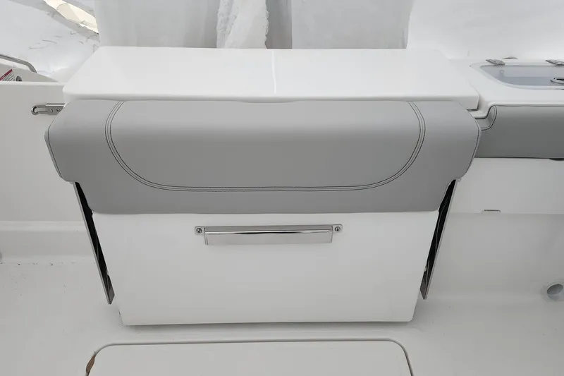 Slide: The Image of 2026 Pursuit DC 266 Dual Console boat seat with gray and white upholstery. - 23