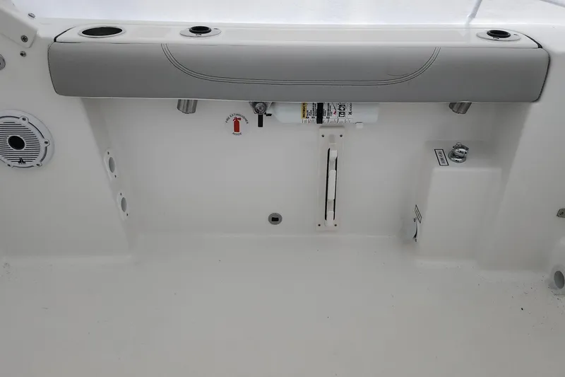 Slide: The Image of 2026 Pursuit DC 266 Dual Console interior with cup holders and fire extinguisher. - 30