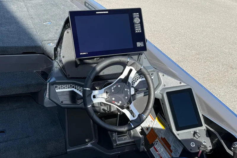 Slide: The Image of 2026 Skeeter FXR21 Apex boat dashboard with advanced navigation display and steering wheel. - 13