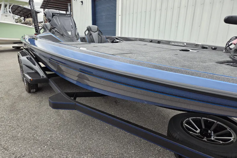 Slide: The Image of 2026 Skeeter FXR21 Apex boat on trailer, showcasing sleek design and modern features. - 8