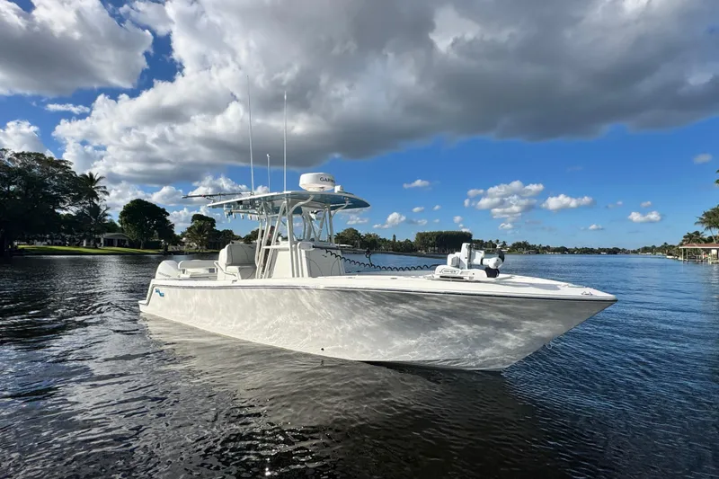 Slide: The Image of 2024 SeaVee 290B boat on calm water under a partly cloudy sky. - 10