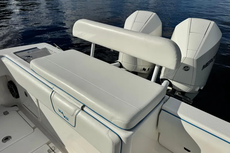 Slide: The Image of 2024 SeaVee 290B boat with dual Mercury engines and cushioned seating. - 12