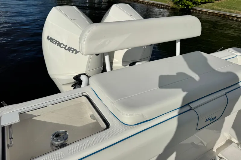 Slide: The Image of 2024 SeaVee 290B boat with Mercury engines, featuring sleek white seating and storage. - 13