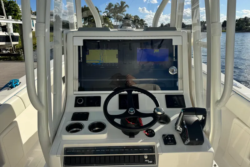 Slide: The Image of 2024 SeaVee 290B boat dashboard with navigation screens and steering wheel. - 17