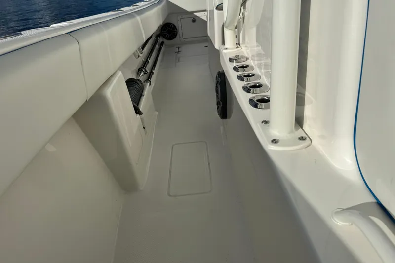 Slide: The Image of 2024 SeaVee 290B boat deck with rod holders and storage compartments. - 19