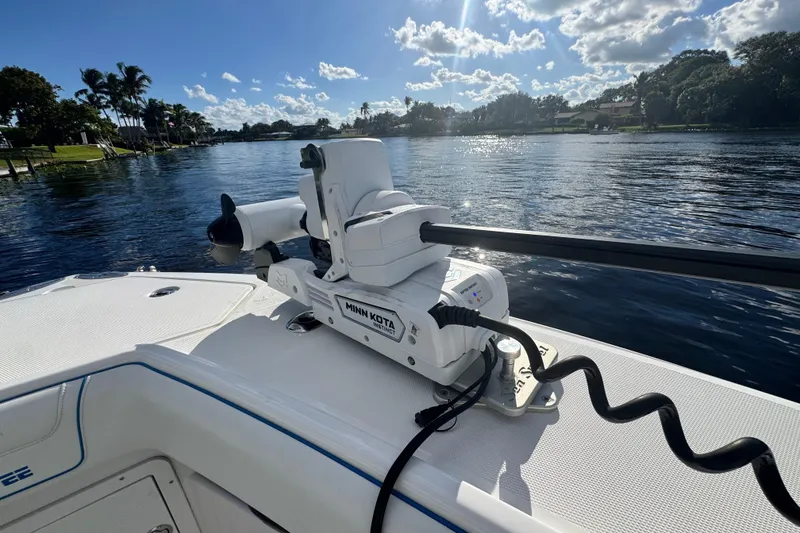Slide: The Image of 2024 SeaVee 290B boat with Minn Kota motor on a sunny day by the water. - 23