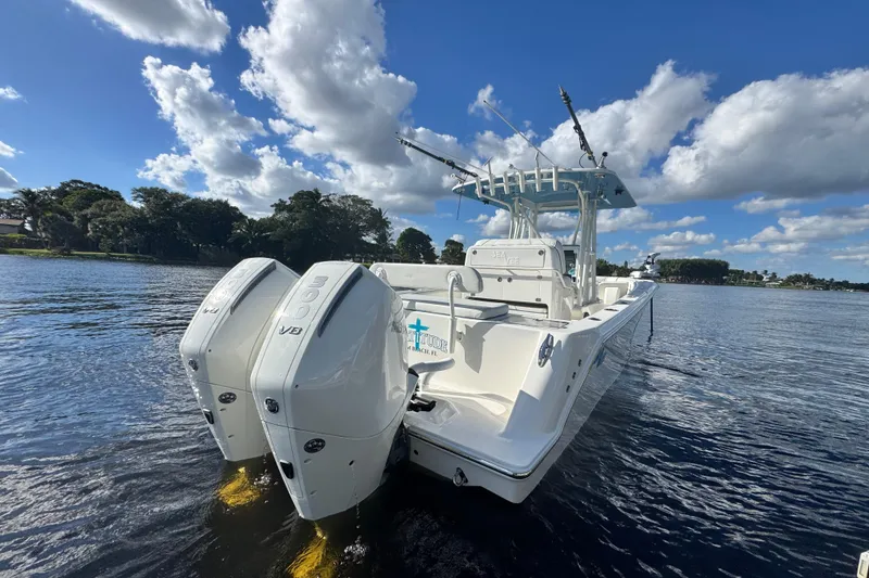 Slide: The Image of 2024 SeaVee 290B boat with dual engines on a sunny day, cruising on calm waters. - 4