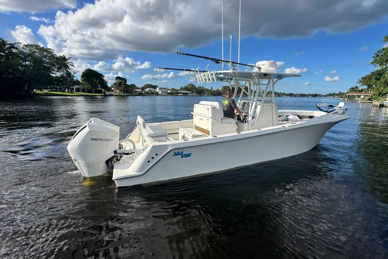 Slide: The Image of 2024 SeaVee 290B boat on calm water, featuring Mercury outboard engine. - 5