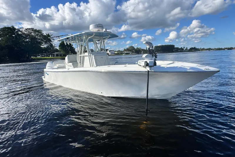 Slide: The Image of 2024 SeaVee 290B boat on calm water under a partly cloudy sky. - 7