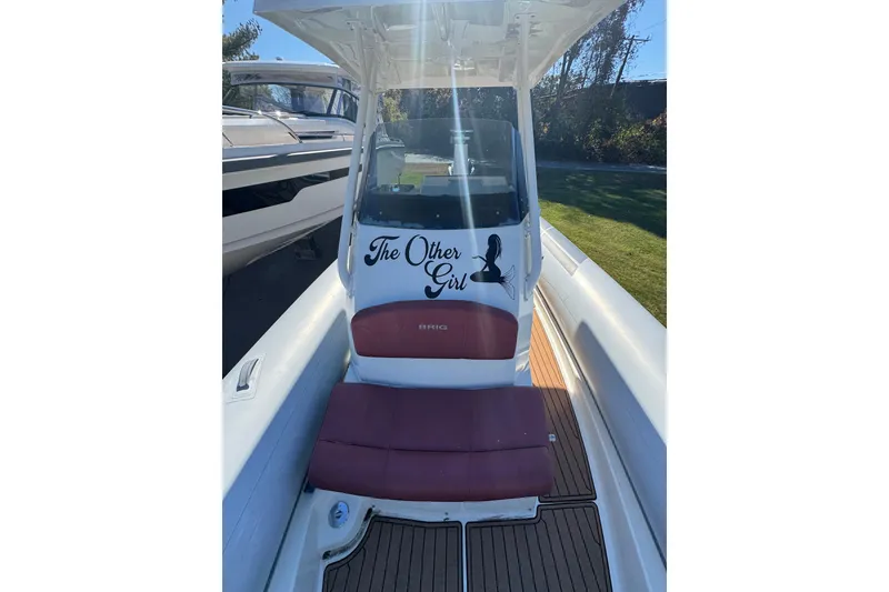 Slide: The Image of 2022 Brig Eagle 8 boat interior with maroon seating and teak flooring. - 20