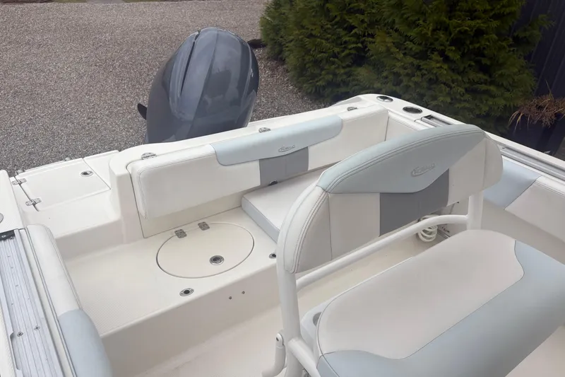 Slide: The Image of 2021 Robalo R202 Explorer boat interior with seating and motor, showcasing sleek design. - 10