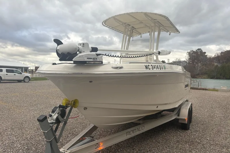 Slide: The Image of 2021 Robalo R202 Explorer boat on trailer, equipped with Minn Kota trolling motor. - 3