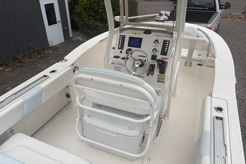 Slide: The Image of 2021 Robalo R202 Explorer boat interior with helm, seating, and controls. - 4