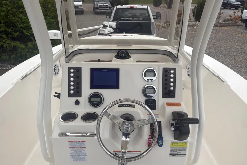 Slide: The Image of 2021 Robalo R202 Explorer boat dashboard with steering wheel and navigation controls. - 6