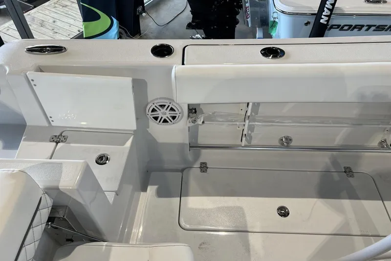 Slide: The Image of 2025 Sportsman Open 252 Center Console boat interior with storage compartments and speaker. - 11