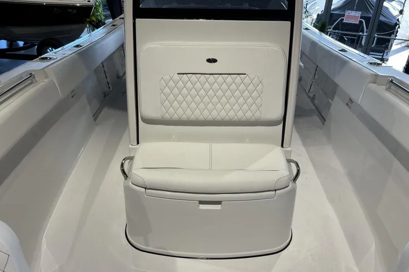 Slide: The Image of 2025 Sportsman Open 252 Center Console boat interior with white seating and sleek design. - 13