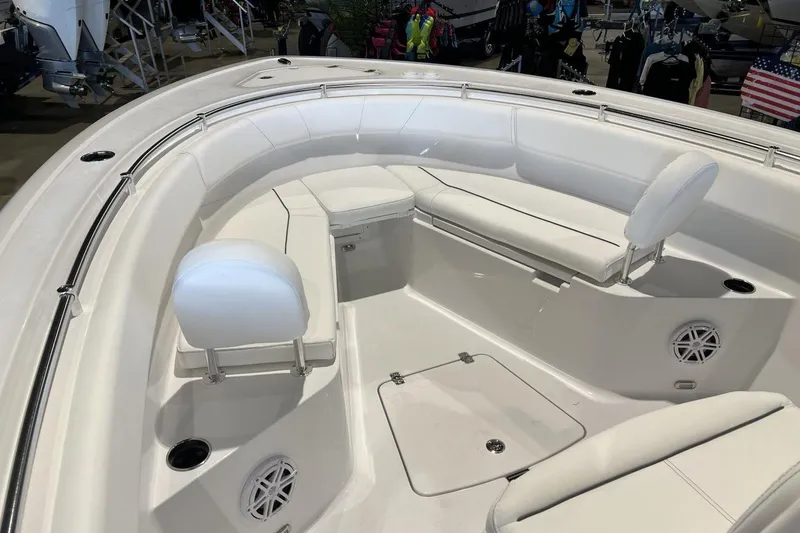 Slide: The Image of 2025 Sportsman Open 252 Center Console boat interior with white seating and speakers. - 15