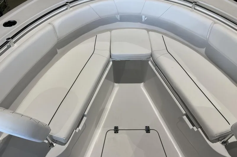 Slide: The Image of 2025 Sportsman Open 252 Center Console boat interior with white cushioned seating. - 16