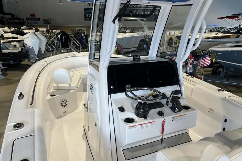 Slide: The Image of 2025 Sportsman Open 252 Center Console boat interior with steering wheel and seating. - 4