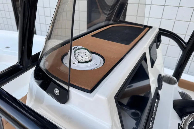 Slide: The Image of 2026 Key West 230 Bay Reef console with compass and navigation equipment. - 12