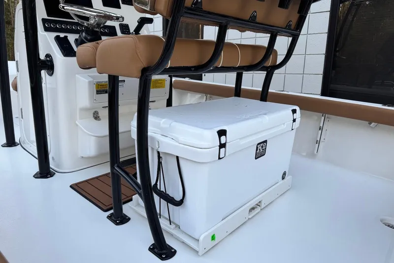 Slide: The Image of 2026 Key West 230 Bay Reef boat interior with seating and cooler. - 17