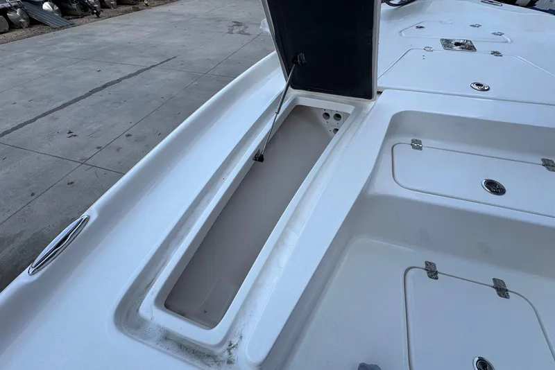 Slide: The Image of 2026 Key West 230 Bay Reef boat deck with open storage compartments. - 19