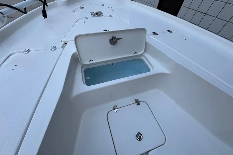 Slide: The Image of 2026 Key West 230 Bay Reef boat deck with open storage compartment. - 22