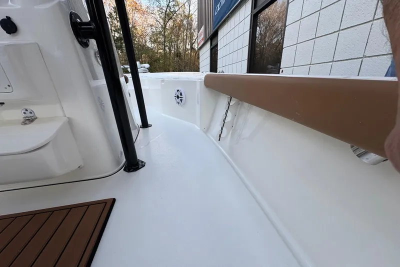 Slide: The Image of 2026 Key West 230 Bay Reef boat interior with white deck and brown trim. - 29