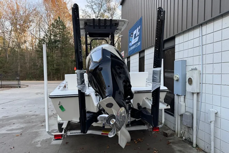 Slide: The Image of 2026 Key West 230 Bay Reef boat with powerful outboard motor, parked outdoors. - 3