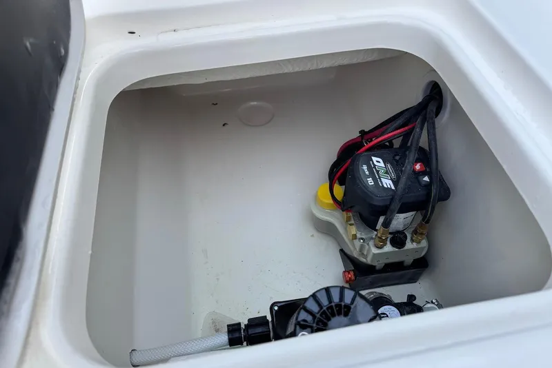 Slide: The Image of 2026 Key West 230 Bay Reef boat compartment with electrical components and wiring. - 31