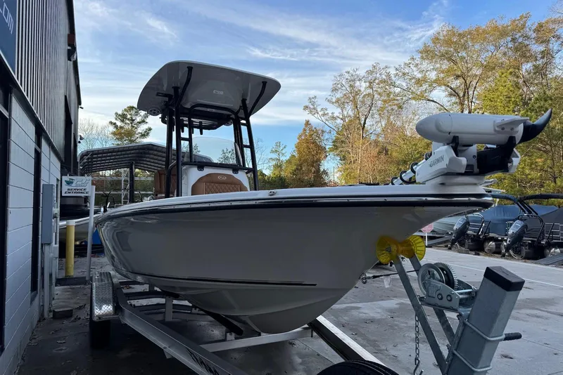 Slide: The Image of 2026 Key West 230 Bay Reef boat on trailer, parked outdoors near service entrance. - 4
