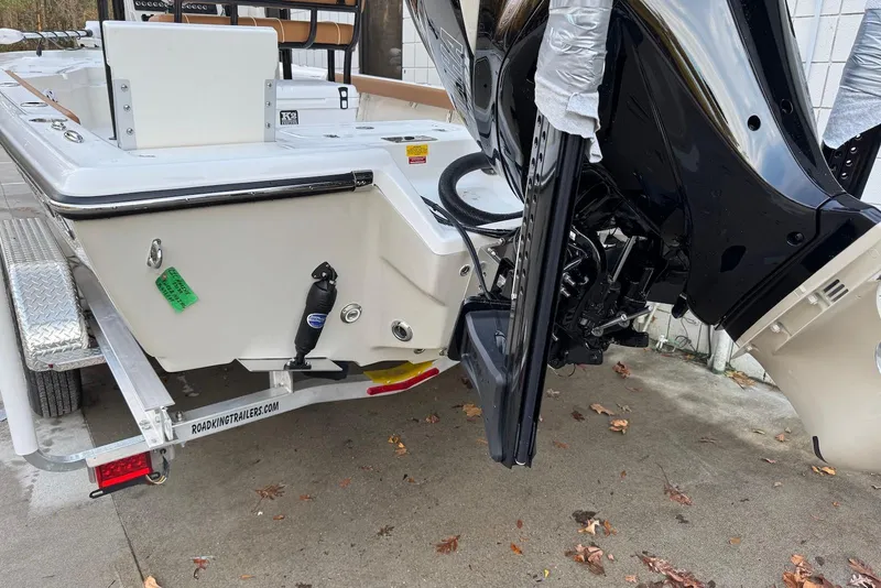 Slide: The Image of 2026 Key West 230 Bay Reef boat on trailer, showcasing motor and rear deck. - 7