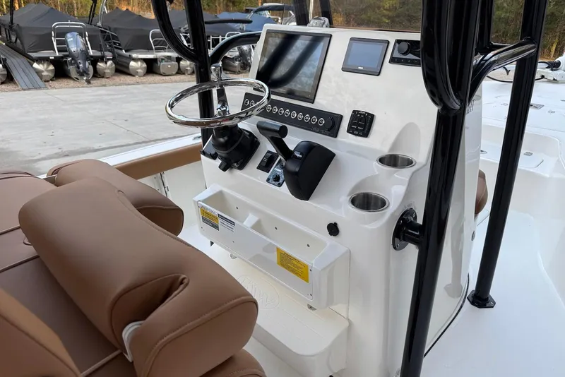 Slide: The Image of 2026 Key West 230 Bay Reef boat console with steering wheel and controls. - 9