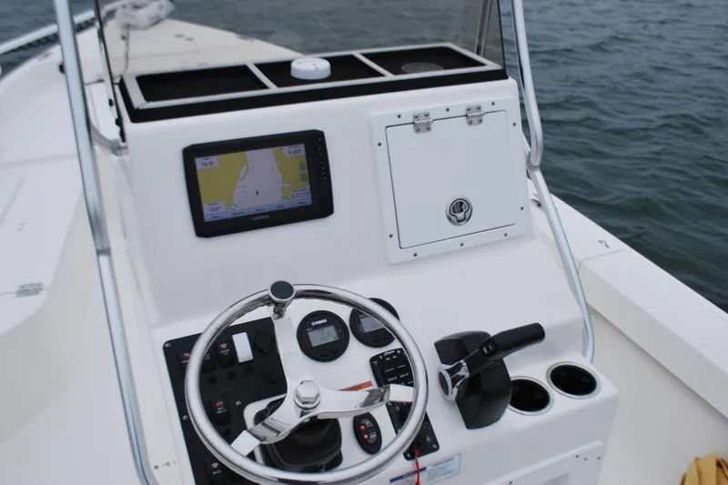 Slide: The Image of 2023 Bay Rider 239 Bay boat console with steering wheel and navigation display. - 13