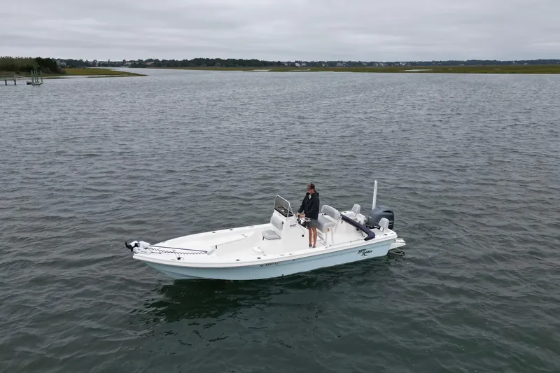 Slide: The Image of 2023 Bay Rider 239 Bay boat on calm water with a person onboard. - 8