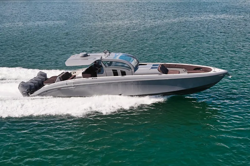 The Image of Midnight Express 52' Vitesse boat cruising on clear blue water. - 0