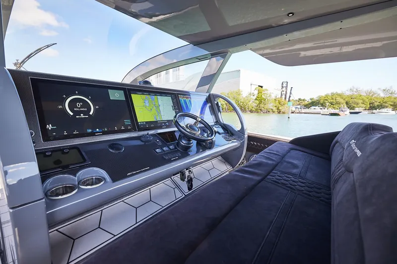 Slide: The Image of Luxurious cockpit of Midnight Express 52' Vitesse yacht with advanced navigation displays and plush seating. - 10